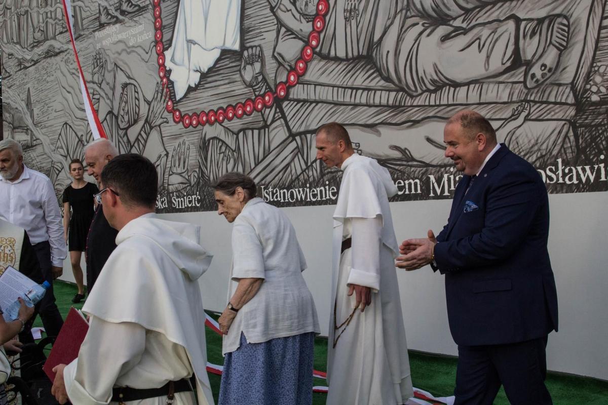 Według naszego eksperta szarfę należy traktować na równi z flagą, a ta nigdy nie powinna dotknąć ziemi. Okoliczności odsłonięcia muralu były jednak specyficzne. Otwartym pozostaje pytanie, czy rozłożony dywan to wystarczający wyraz szacunku dla symboli narodowych.<br/>fot.Bartłomiej Pacek