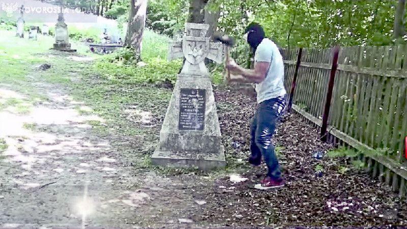 „Cichociemny” rozbija młotem tablicę na krzyżu w Radrużu – kadr z filmu emitowanego przez portal Noworossia Today.